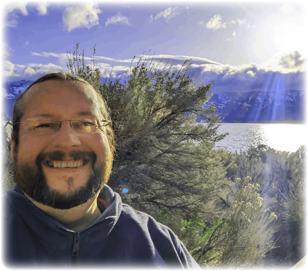 Scott standing in front of Washoe Lake at sunset